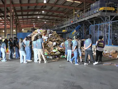Volunteers at recycling processing center