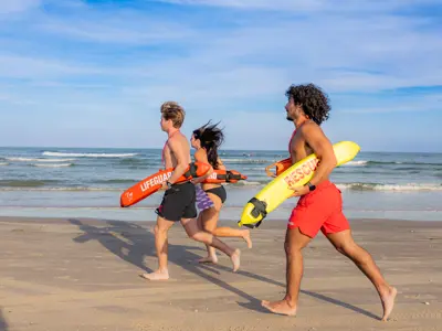 lifeguards running on the beach