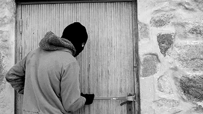 A man breaking into a building