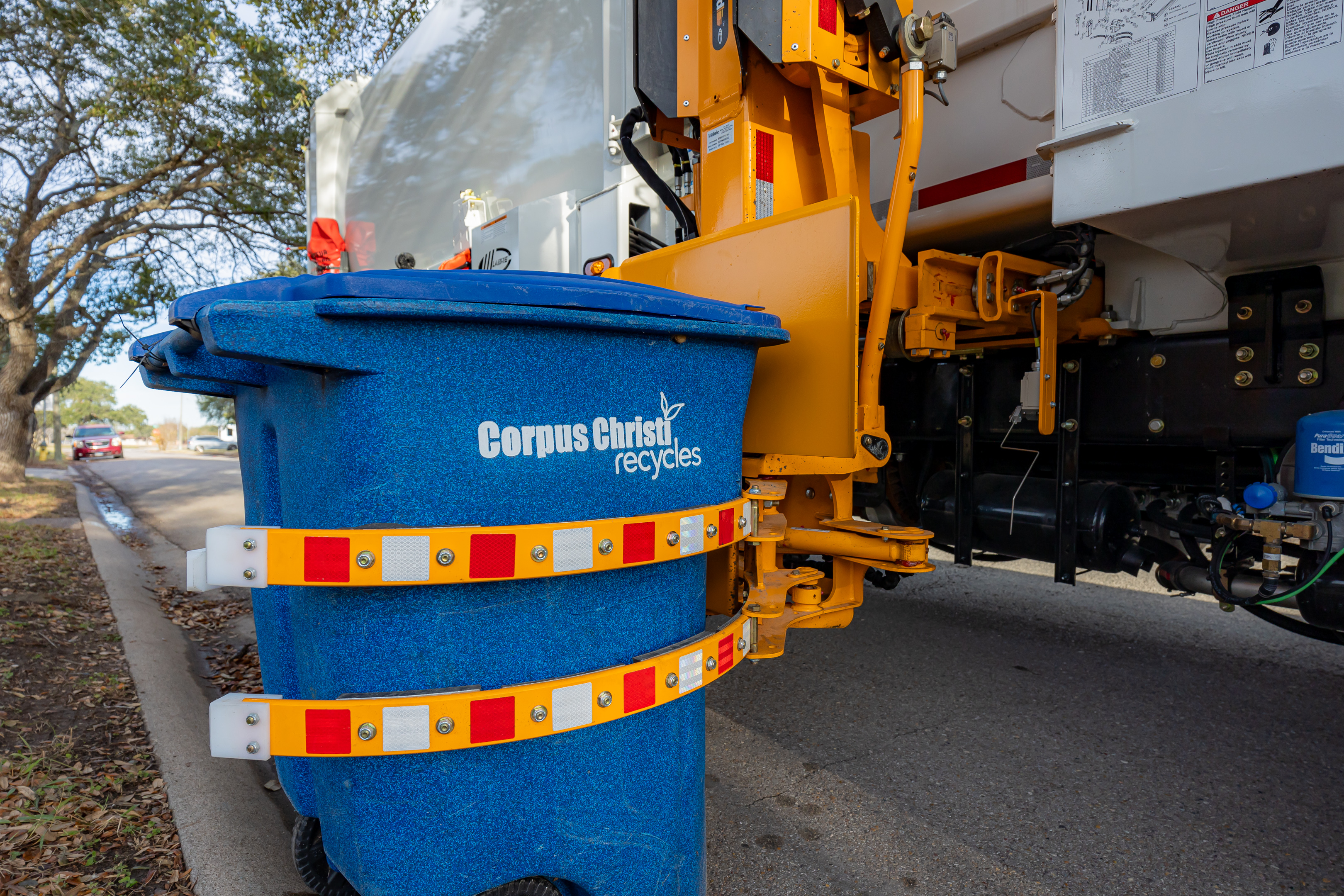 Truck lifting garbage can