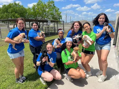 group photo of volunteers holding pets
